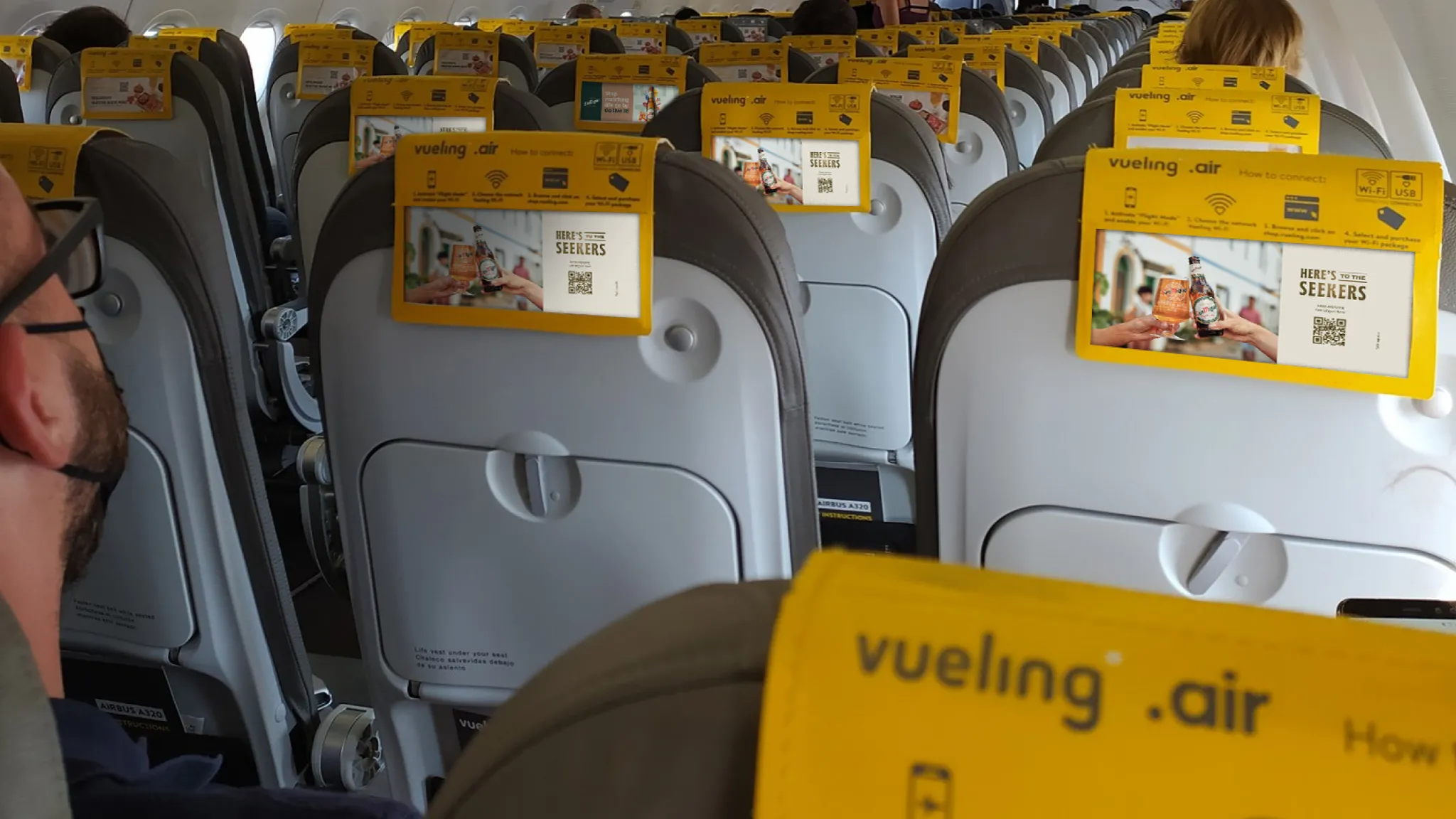 San Miguel advertising visible on Vueling airline seatbacks.